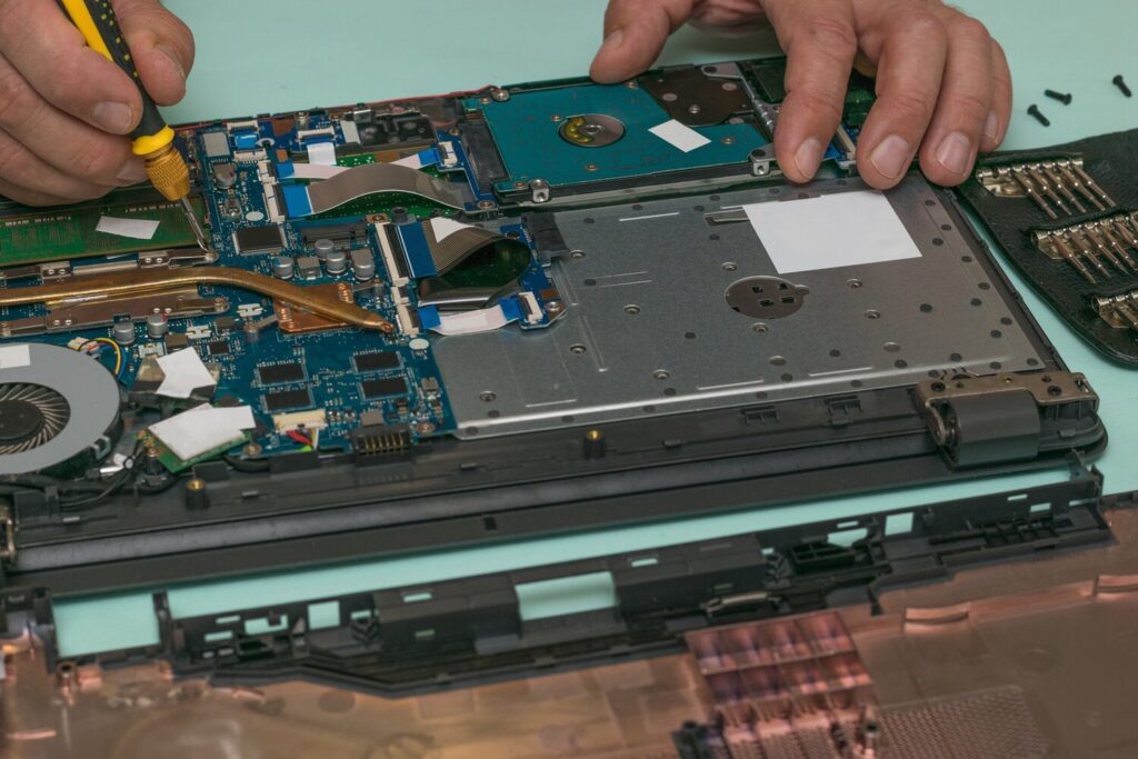 man performs replacement parts laptop repair restore laptop performance 94064 4456